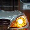 Technician restoring car headlight